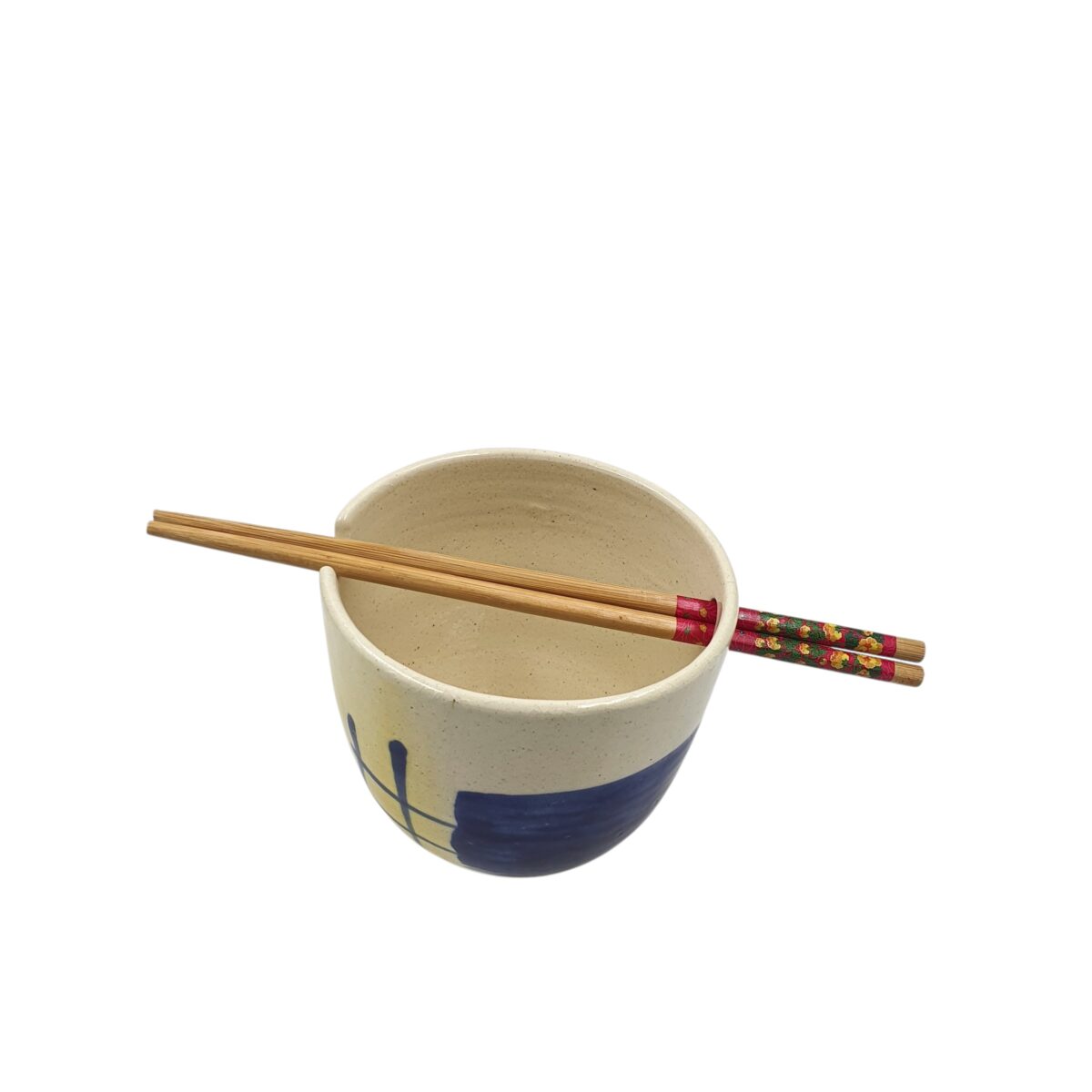 Top view into the deep, wide ramen bowl with chopsticks across the rim