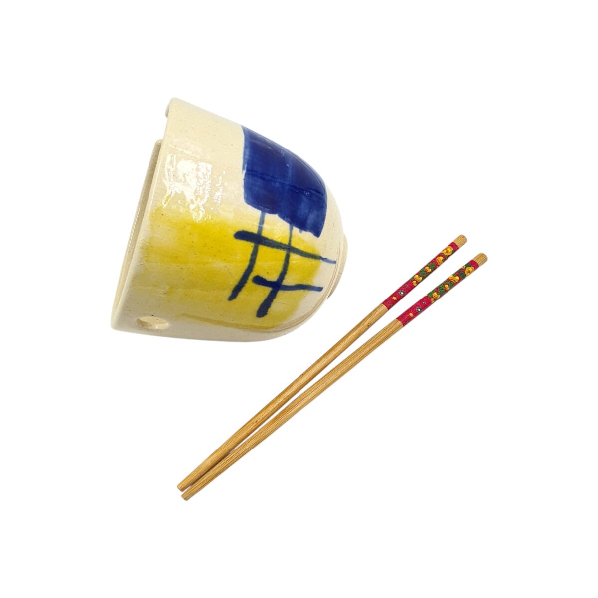 The ramen bowl tilted to show its gently flared rim and abstract glaze